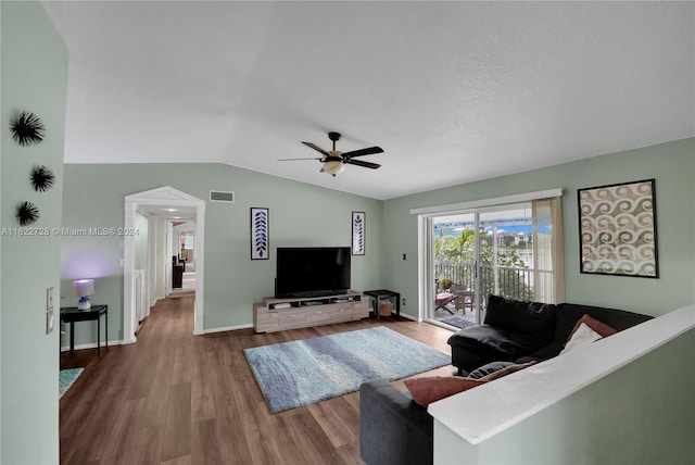 living room with lofted ceiling, wood-type flooring, and ceiling fan