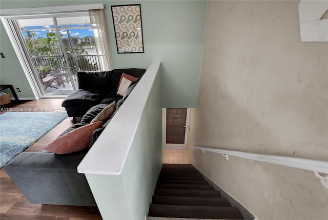 stairway with hardwood / wood-style floors