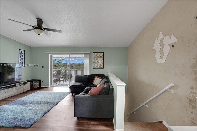 living room with wood-type flooring and ceiling fan