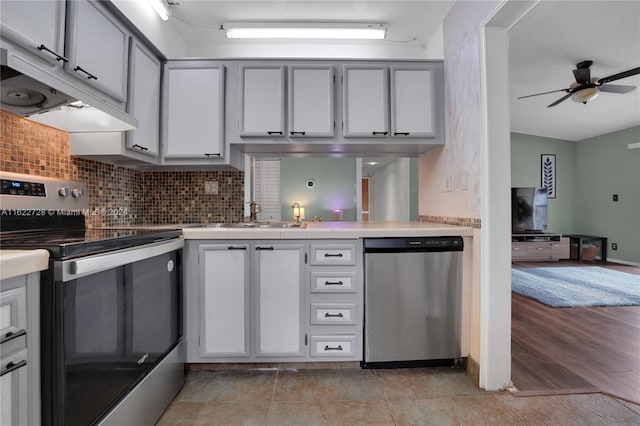 kitchen featuring ceiling fan, light hardwood / wood-style floors, appliances with stainless steel finishes, decorative backsplash, and sink