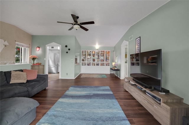 living room with lofted ceiling, ceiling fan, and dark wood-type flooring