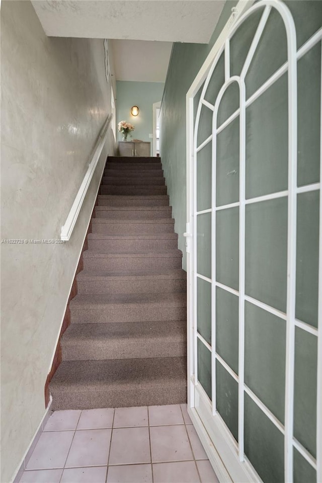 stairs with tile patterned floors