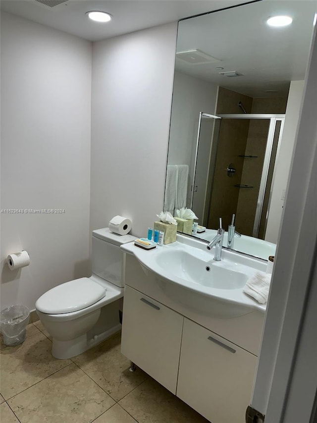 bathroom with vanity, tile patterned flooring, and toilet