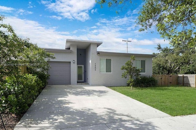 view of front of property with a garage and a front lawn