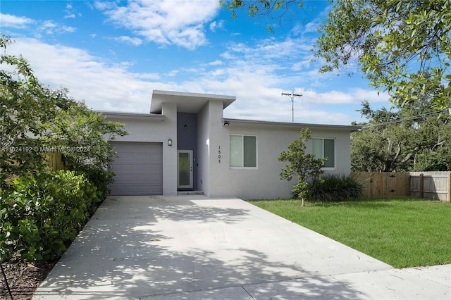 view of front facade with a garage and a front yard