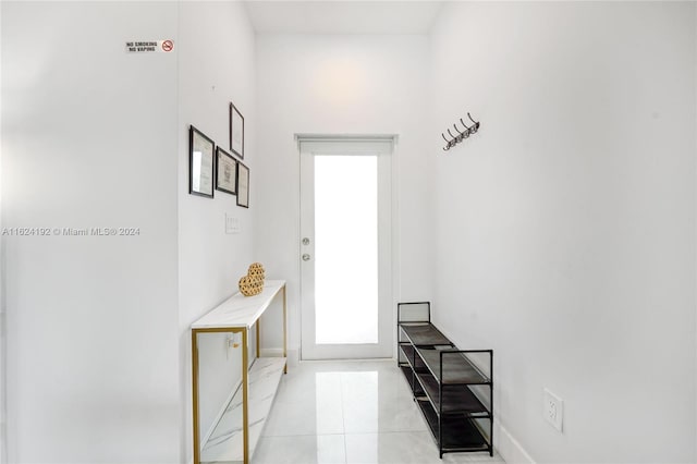 doorway with light tile patterned flooring