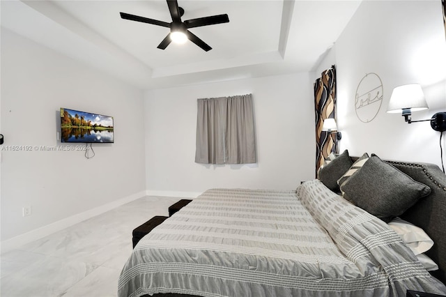 bedroom featuring a raised ceiling, light tile patterned floors, and ceiling fan