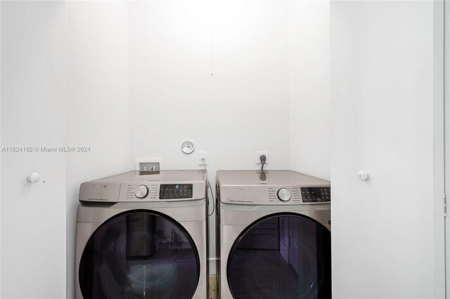 clothes washing area with independent washer and dryer