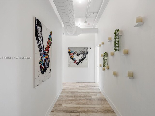 corridor with light wood-type flooring