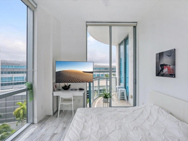 bedroom featuring light hardwood / wood-style floors and floor to ceiling windows