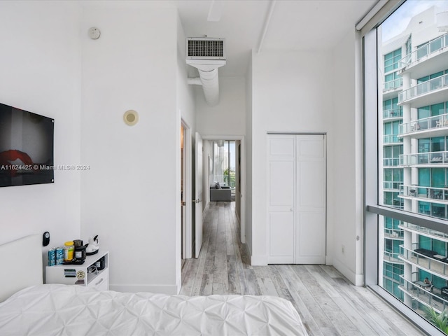 bedroom with light wood-type flooring and a closet