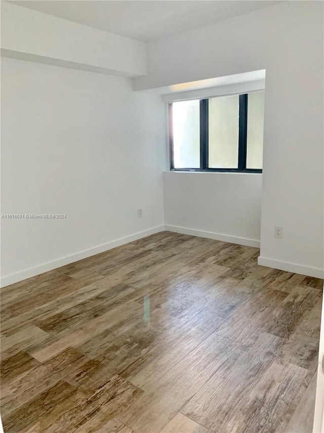 empty room featuring wood-type flooring