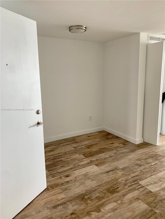 spare room featuring hardwood / wood-style flooring