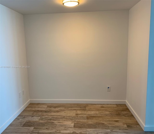 empty room with hardwood / wood-style flooring