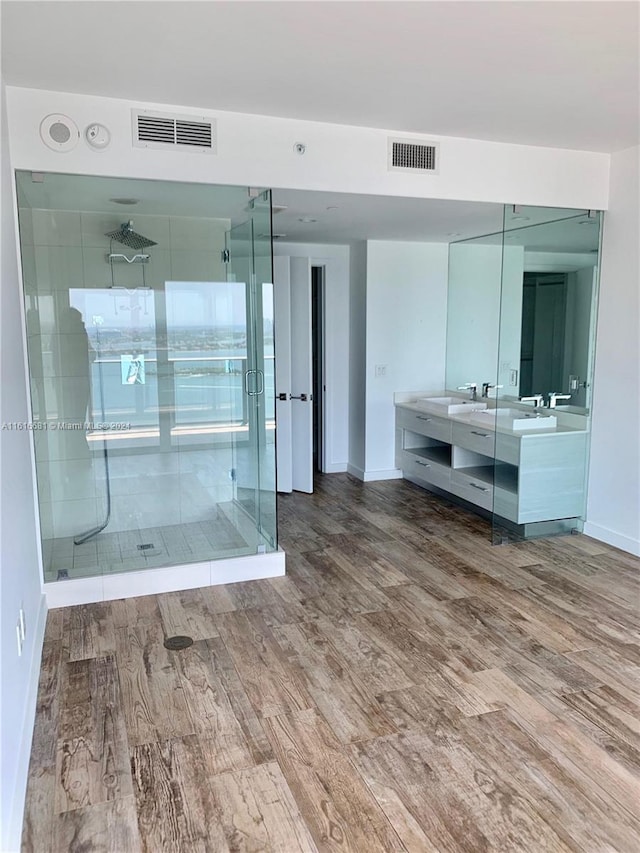 bathroom with an enclosed shower, vanity, and hardwood / wood-style flooring