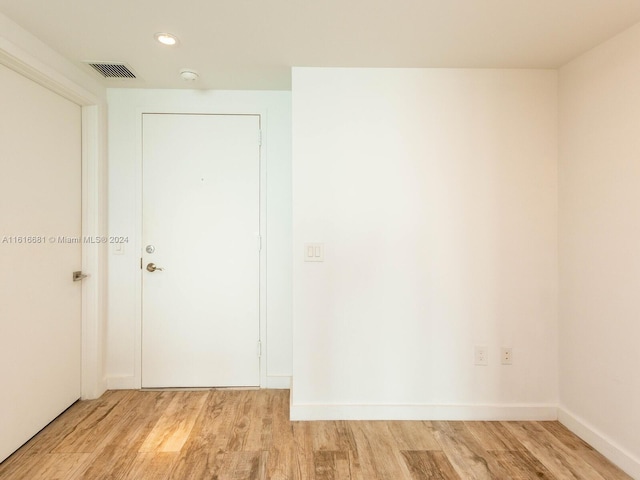 empty room with light hardwood / wood-style flooring