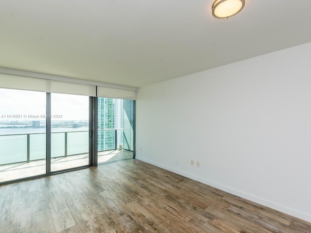 empty room featuring hardwood / wood-style flooring and floor to ceiling windows
