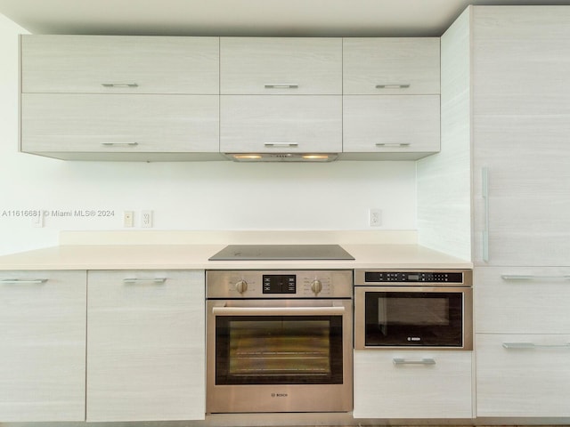 kitchen featuring black electric cooktop and stainless steel oven