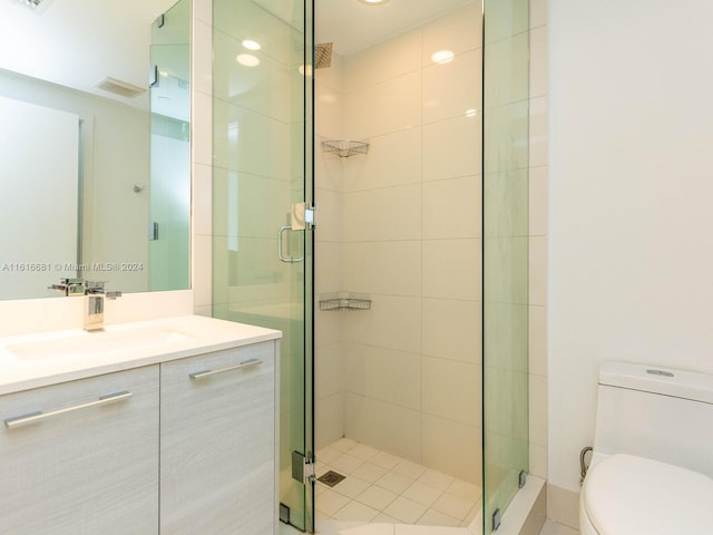 bathroom featuring vanity, toilet, and an enclosed shower