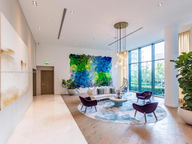 living room featuring expansive windows and light wood-type flooring