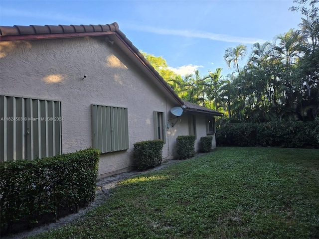 view of property exterior featuring a yard