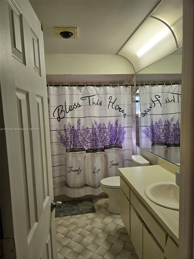 bathroom with vanity, toilet, and walk in shower