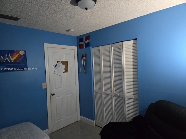 bedroom with a closet and a textured ceiling