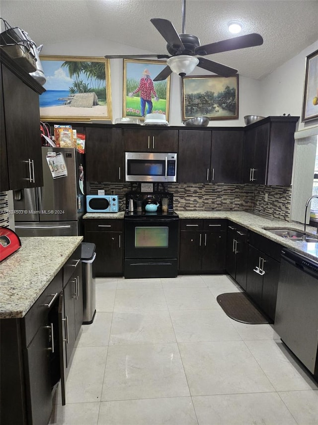 kitchen featuring a textured ceiling, stainless steel appliances, tasteful backsplash, and sink