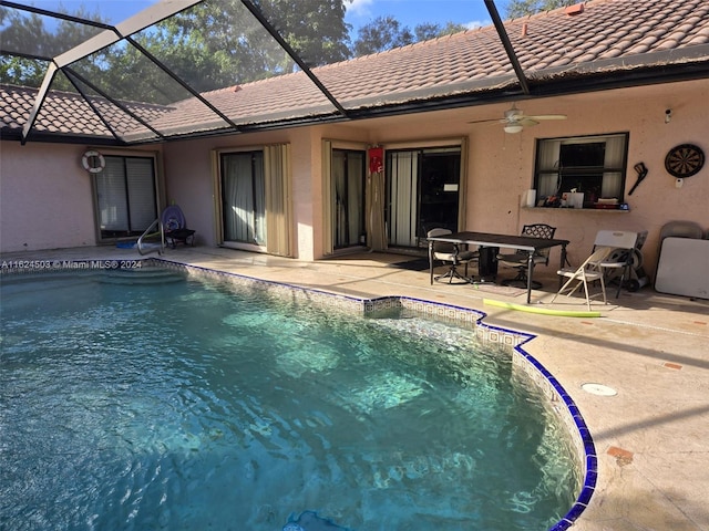 view of pool with ceiling fan, a patio, and glass enclosure