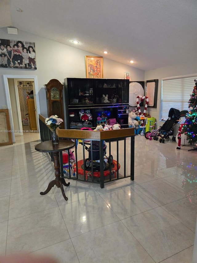 living room featuring tile patterned floors and lofted ceiling