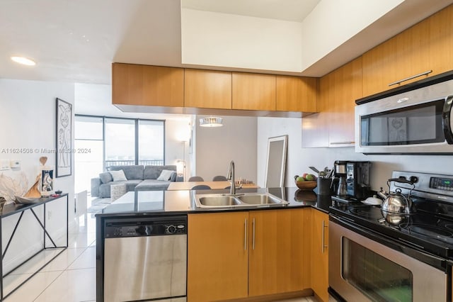 kitchen featuring light tile patterned floors, sink, and appliances with stainless steel finishes