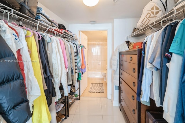 walk in closet with light tile patterned floors