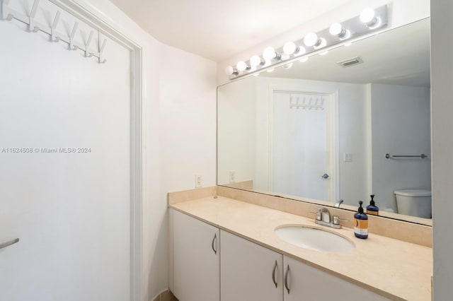 bathroom with toilet and vanity