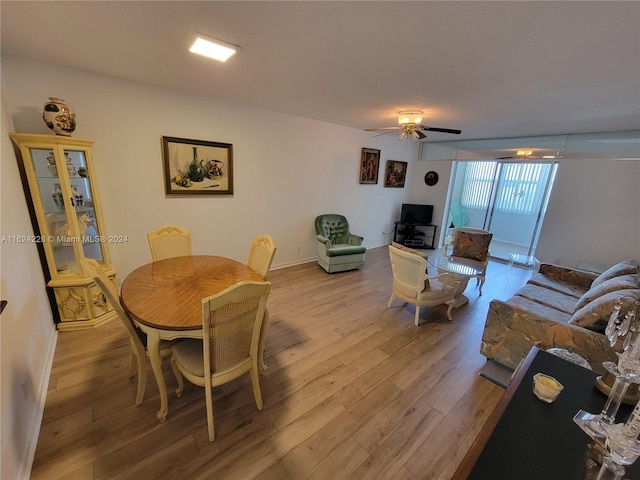 dining area with ceiling fan, light hardwood / wood-style flooring, and expansive windows