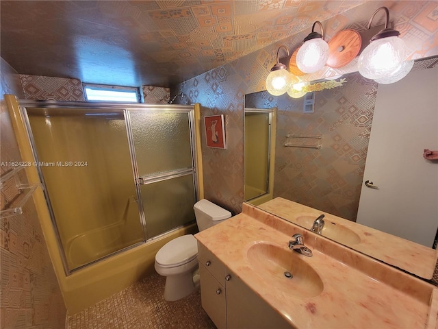 full bathroom featuring shower / bath combination with glass door, vanity, and toilet