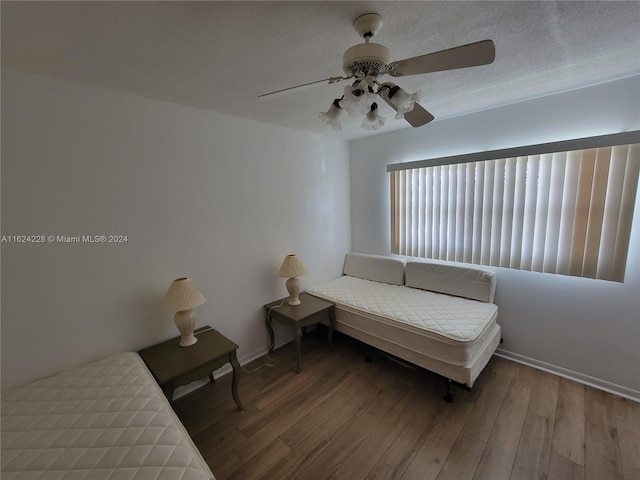 bedroom with ceiling fan and hardwood / wood-style floors