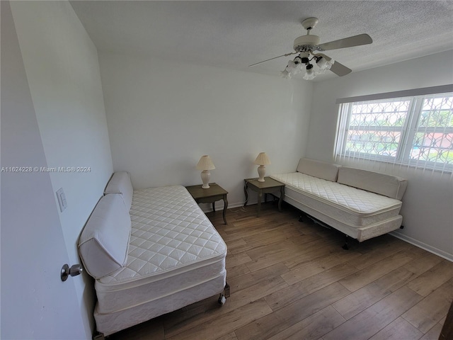 bedroom with hardwood / wood-style flooring and ceiling fan