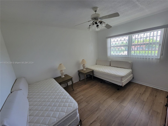 bedroom with ceiling fan and hardwood / wood-style flooring