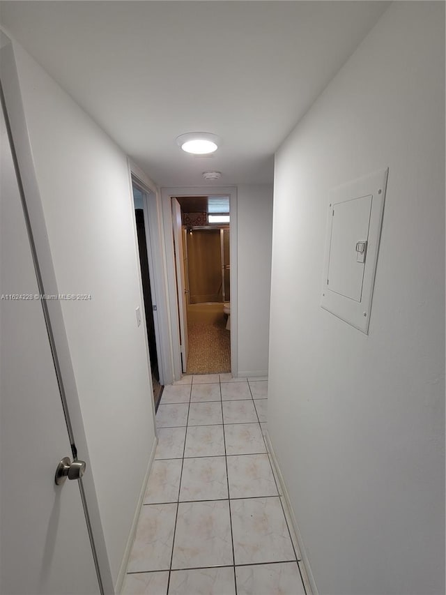 corridor with electric panel and light tile patterned floors