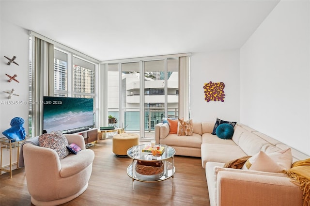 living room featuring wood-type flooring and floor to ceiling windows