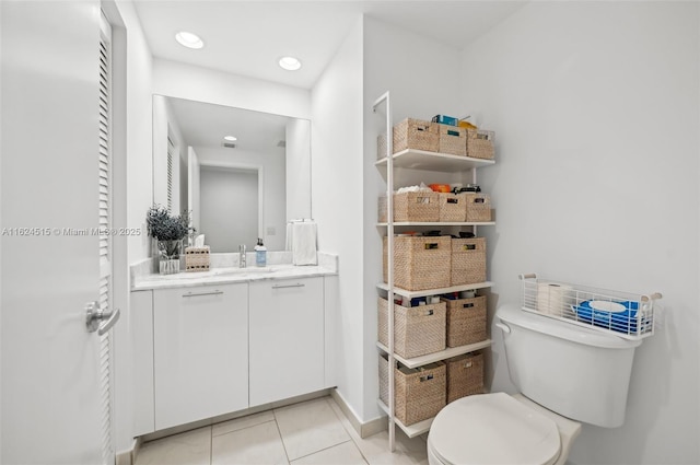 bathroom featuring tile patterned flooring, vanity, and toilet