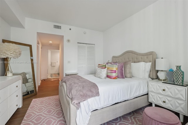 bedroom featuring a closet and dark hardwood / wood-style floors