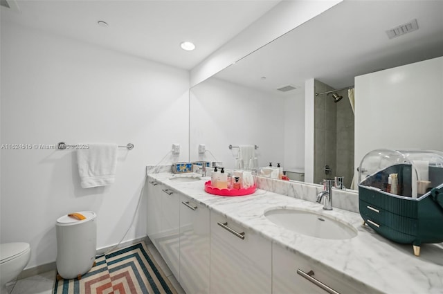 bathroom featuring tile patterned flooring, vanity, curtained shower, and toilet