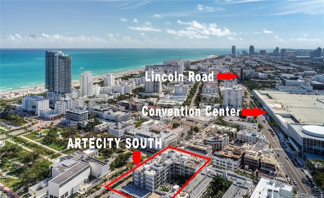 aerial view featuring a water view and a view of the beach