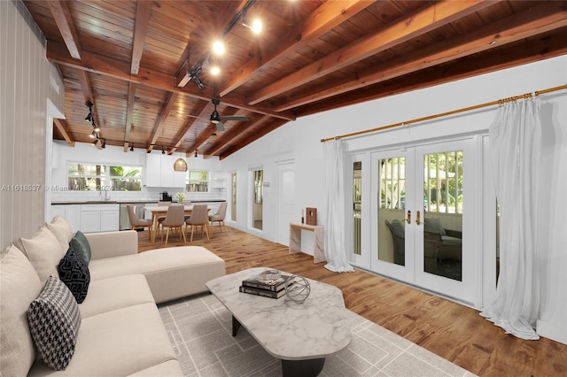 living room featuring wooden ceiling, lofted ceiling with beams, french doors, light hardwood / wood-style floors, and track lighting