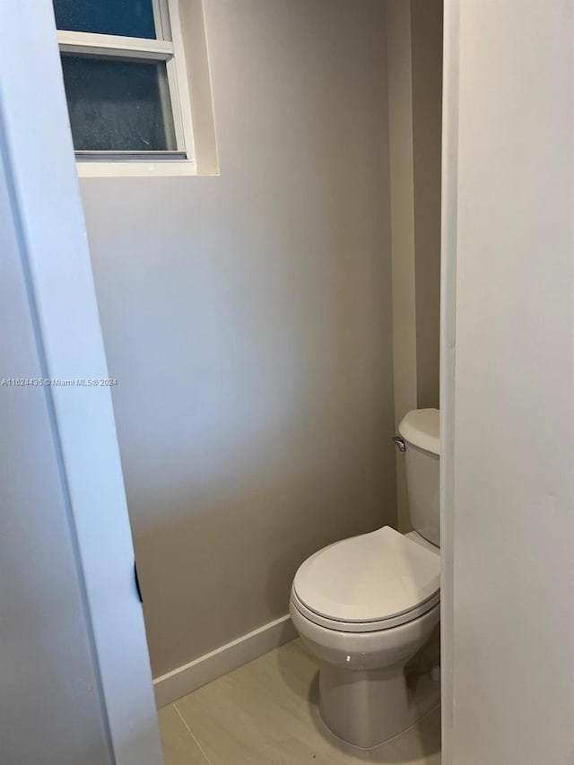 bathroom featuring tile patterned floors and toilet