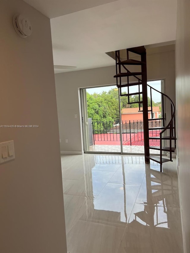 6580 W Flagler St Unit 309, Miami, FL 33144 - tiled empty room with stairs and baseboards
