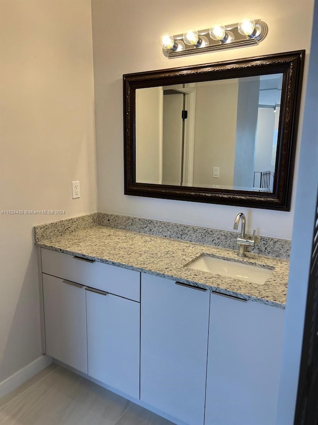 bathroom featuring tile patterned flooring and vanity