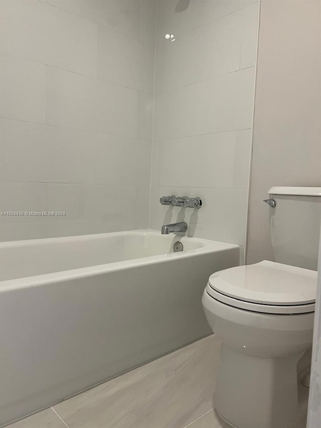 bathroom featuring tile patterned flooring and toilet