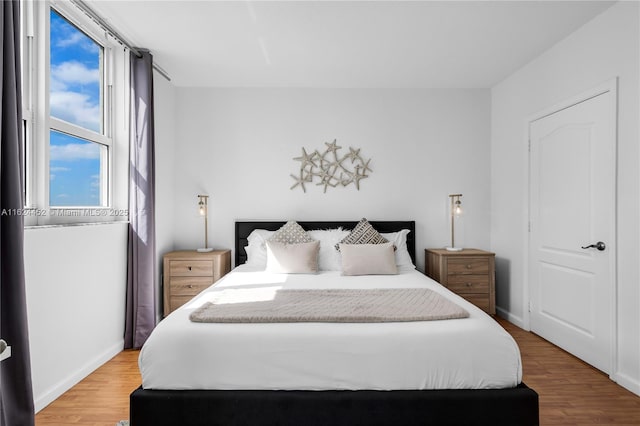 bedroom with hardwood / wood-style floors